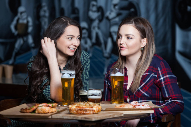 Party girls. Beautiful girls drinking beer. - Фото, изображение