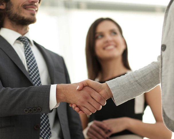 Businesspeople  shaking hands against room with large window loo - Фото, зображення