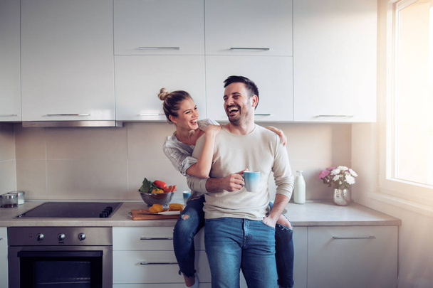 Romantic young couple cooking together in kitchen - Photo, Image