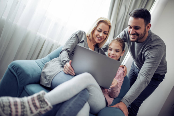 Família assistindo filme no laptop em casa
 - Foto, Imagem
