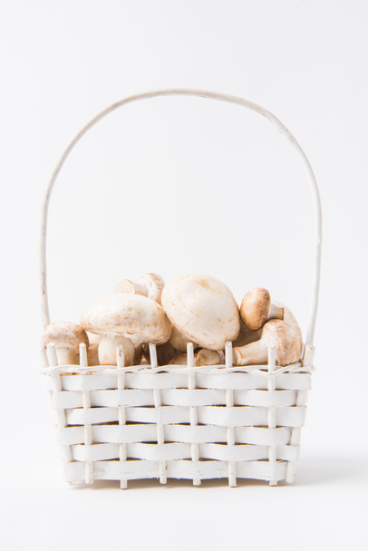 heap of mushrooms laying in wicker basket on white background   - Photo, Image