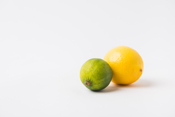 green lime and lemon laying on white background   - Photo, Image