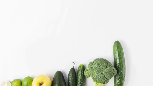 Creating composition of green vegetables in a row isolated on white background - Footage, Video