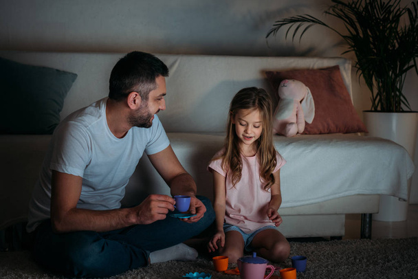 father and daughter pretending to have tea party together at home - Photo, image