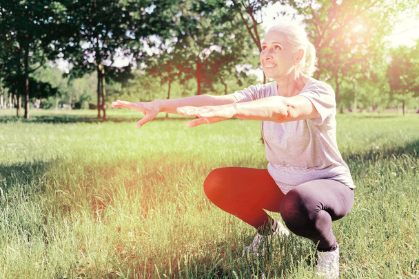 Full length of delighted elderly woman doing exercises - Photo, Image