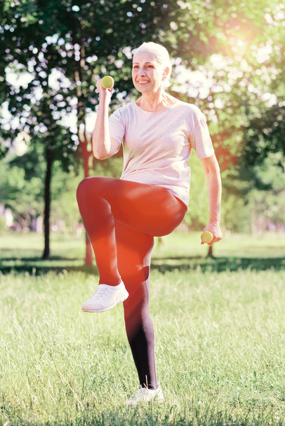 Enthusiastic elderly woman with weights - Фото, зображення