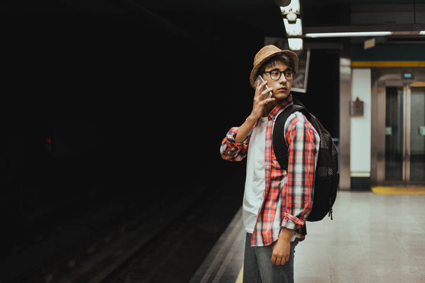 young handsome man in hat using mobile phone  - 写真・画像