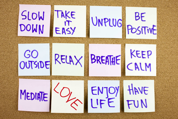A yellow sticky note writing, caption, inscription Slow down, take ir easy be positive go outside relax breathe keep calm love what you do, do what you love, motivational concept on sticky notes - Photo, Image