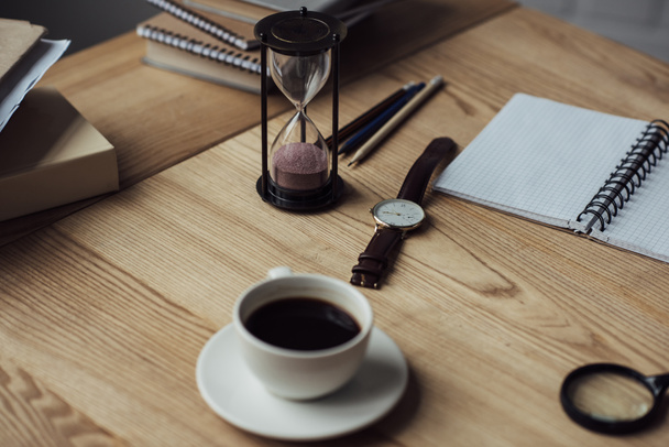 cup of coffee white hourglass and watch on workplace - Photo, Image