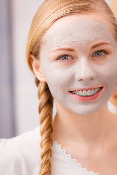 Woman with clay mud mask on her face - Valokuva, kuva