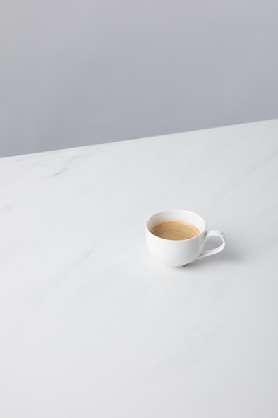 View of cup with coffee on white surface - Photo, Image