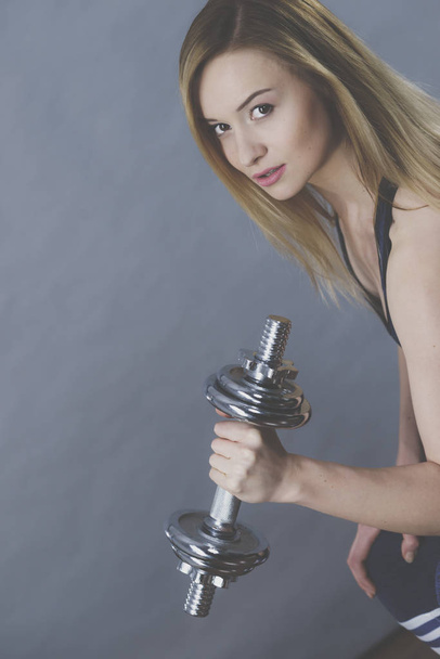 Fit woman lifting dumbbells weights - Fotoğraf, Görsel