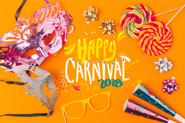 flat lay with lollipops and party objects isolated on orange, carnival concept - Fotó, kép