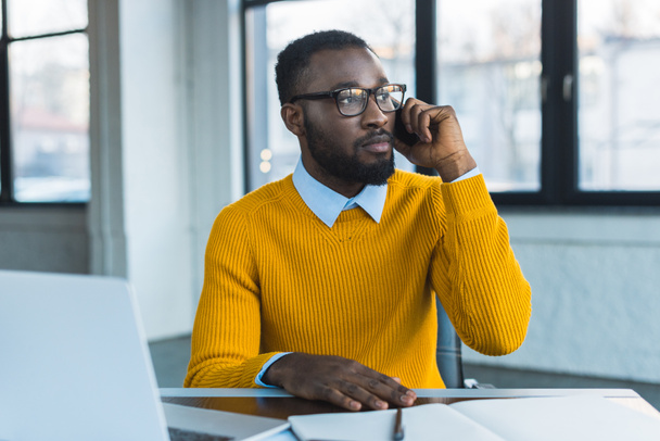 Αφρικανικός Αμερικανός επιχειρηματίας, μιλώντας από το smartphone στο γραφείο - Φωτογραφία, εικόνα