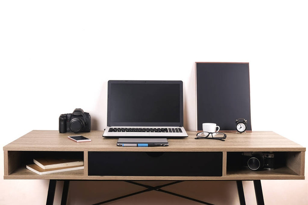 Photo blogger / photographer / it specialist's typical office space table with laptop, blank screen, coffee cup and electronics. Top view, copy space, flat lay, overhead, backdrop. - Photo, Image