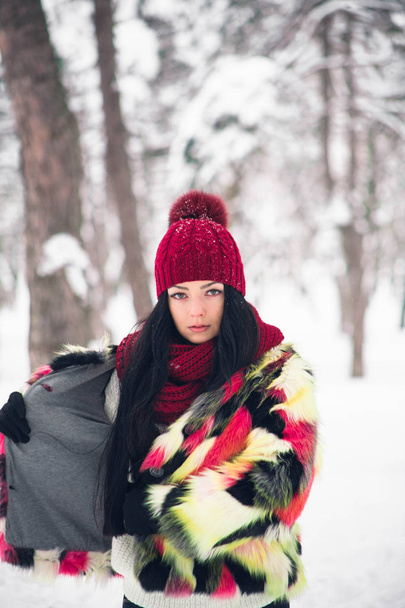 Young woman in multi-colored fur coat - Фото, изображение