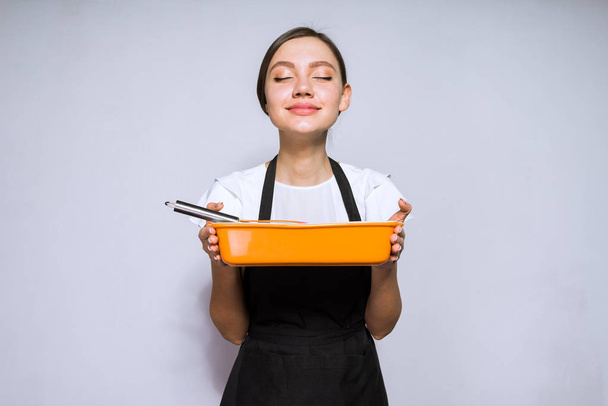 cute young woman chef in black apron cooked a delicious pie - Photo, image
