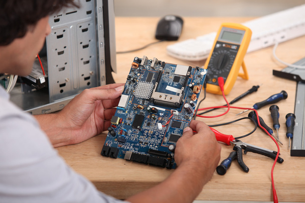 Man working on a circuit board - Photo, image