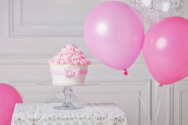 Festive cake and balloons. White and pink color - 写真・画像