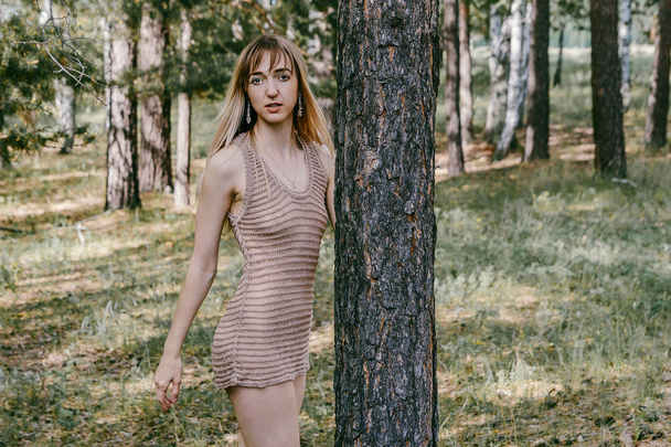 skinny girl in sheer tank top near the tree - Fotografie, Obrázek