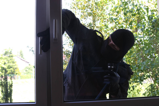 criminal Burglar in black clothes in balaclava on head - Photo, Image