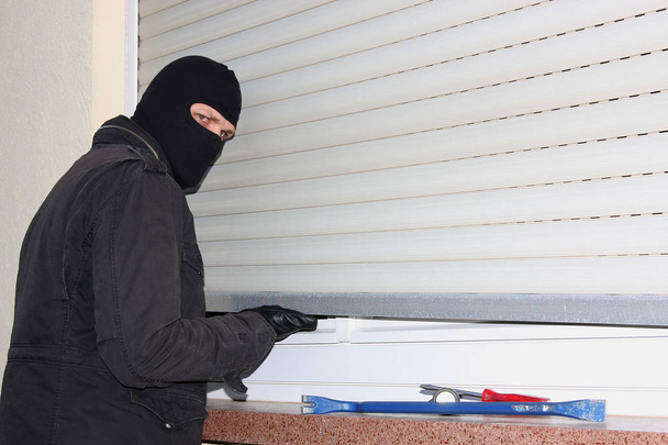 criminal Burglar in black clothes in balaclava on head - Foto, Imagen