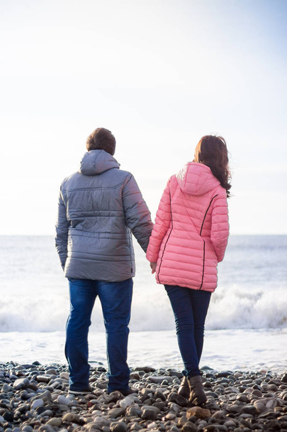 Lovers walk near the sea in winter - Photo, Image
