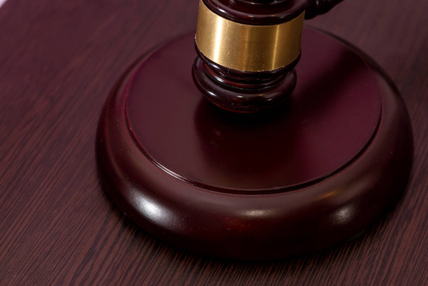 Judge hammer on brown wooden desk close up. - Photo, Image