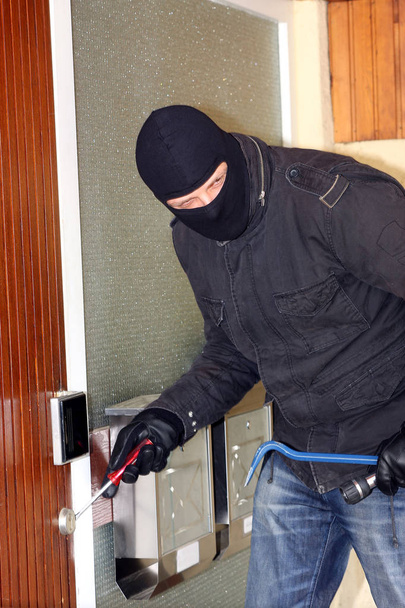 criminal Burglar in black clothes in balaclava on head - Фото, зображення