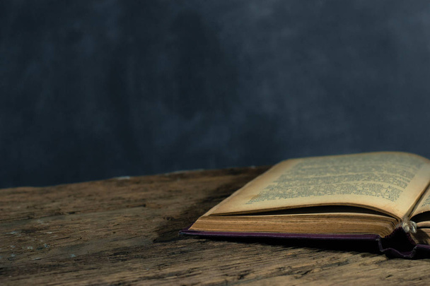 Old book on a  wooden table. Beautiful background. - Foto, afbeelding