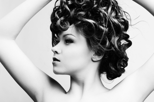 Beautiful woman with long curly hair - Fotó, kép