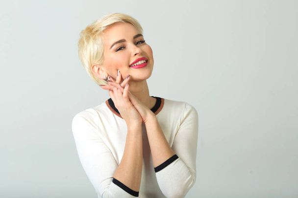beautiful young girl with short hair style smiling on white background - Φωτογραφία, εικόνα