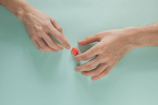 Male and female hand meet each other on a colored background - Foto, immagini