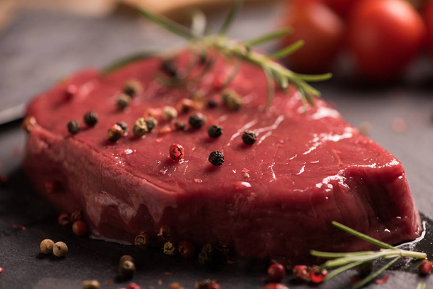 Raw beef steak on a dark wooden table. - Valokuva, kuva