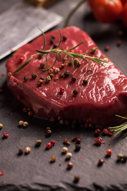 Raw beef steak on a dark wooden table. - Valokuva, kuva
