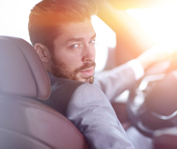 Close-up of a businessman sitting at the wheel of a car - Foto, Imagem