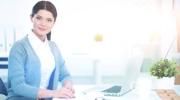 Portrait of a businesswoman sitting at  desk with  laptop - Фото, изображение