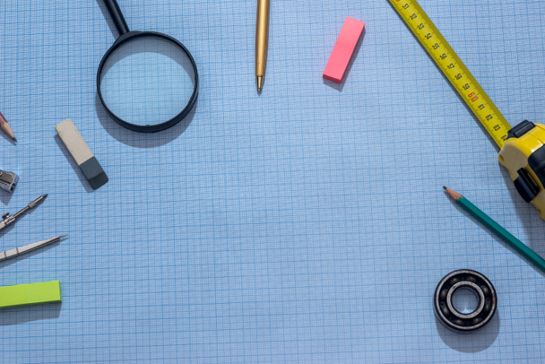 pencil, compass and rulers on graph paper background - Photo, image