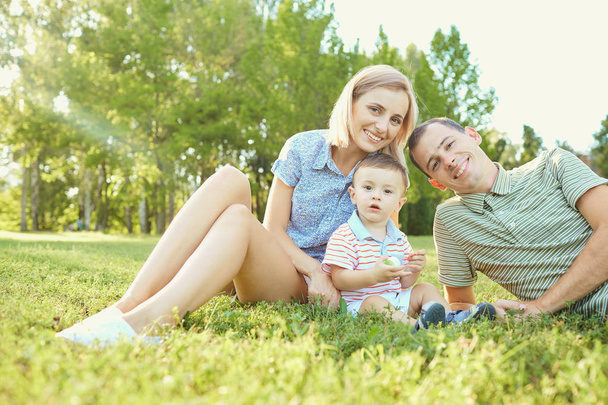 Portrait of a happy family in the park.  - Фото, изображение