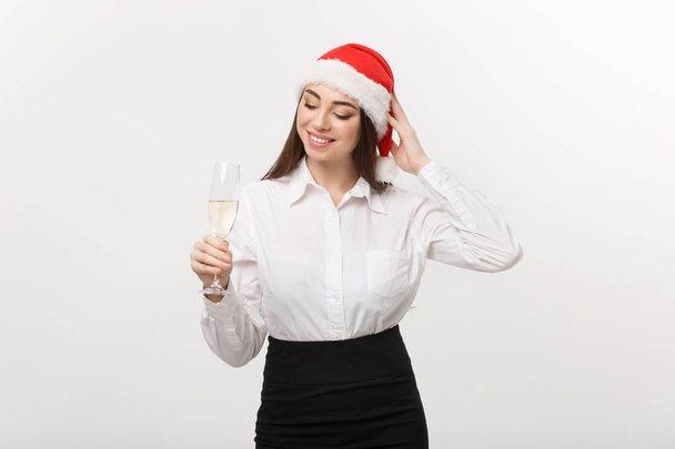 Christmas Celebration - Young beautiful business woman celebrating christmas with glass of champagne. - Фото, изображение