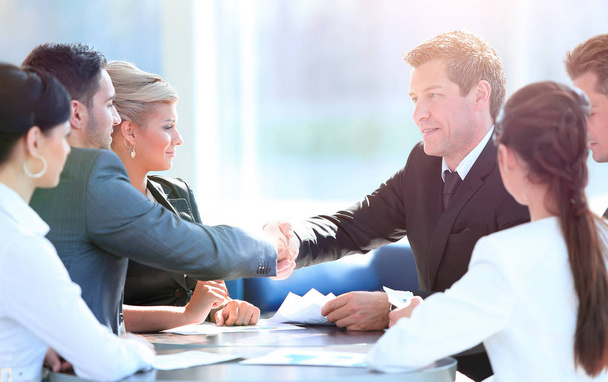 two business partners shaking hands on meeting - Фото, зображення