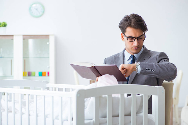Young businessman trying to work from home caring after newborn  - Photo, Image
