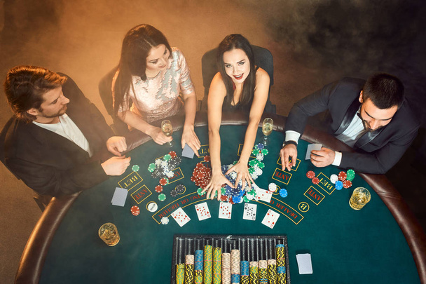 Πόκερ παίκτες που κάθονται γύρω από ένα τραπέζι σε μια χαρτοπαικτική λέσχη. Το Top view - Φωτογραφία, εικόνα
