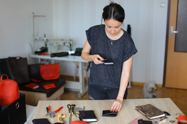     Girl taking pictures of handmade notebook using smartphone. - Foto, Imagem