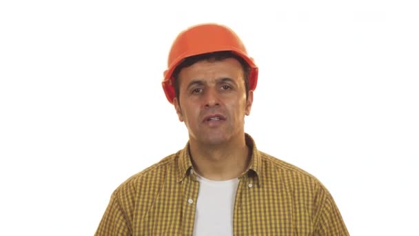 Professional constructionist looking shocked taking off his hardhat - Filmati, video