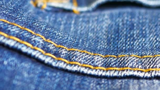 Blue denim jeans close up stock footage close up with a sliding camera move. - Imágenes, Vídeo
