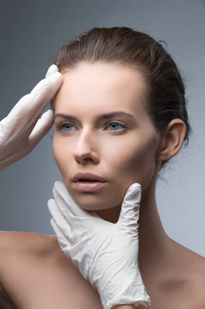 Portrait of young Caucasian woman getting cosmetic injection - Foto, immagini