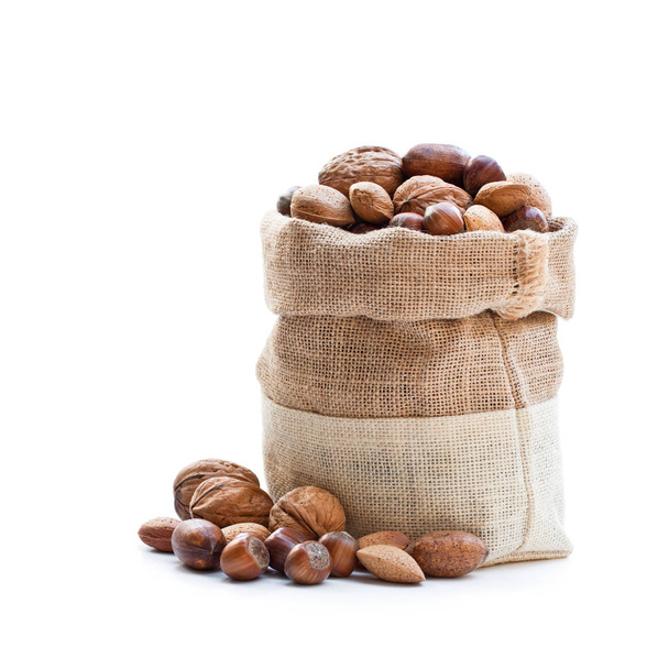 Various  nuts in sackcloth bag isolated on white  - Photo, Image