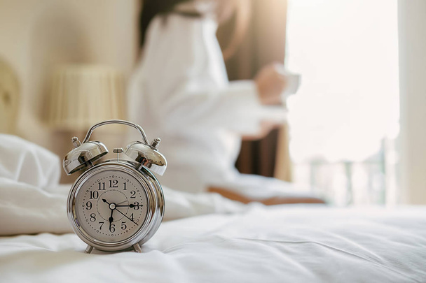 Alarm clock standing on bedside table has already rung early mor - Фото, зображення