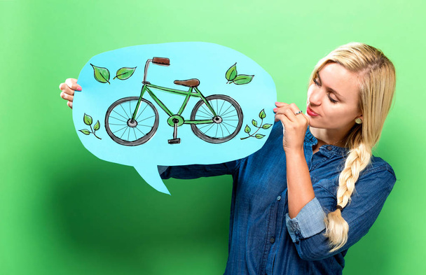 Eco Bicycle with woman holding a speech bubble - Zdjęcie, obraz